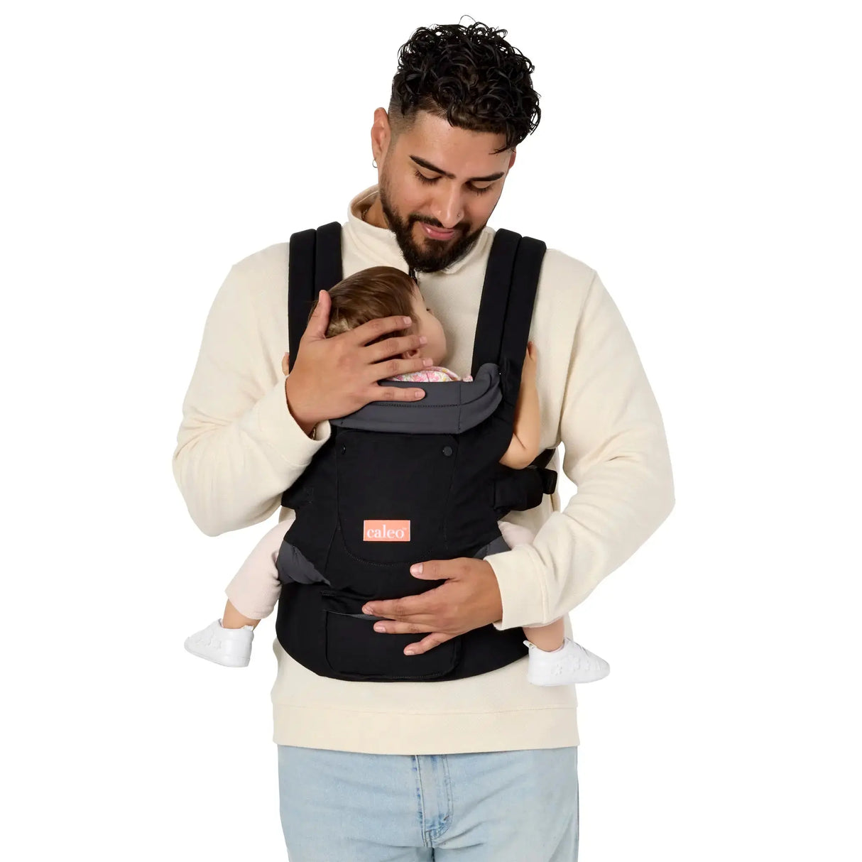 A man carrying a child in the Caleo 3-in-1 Newborn Carrier