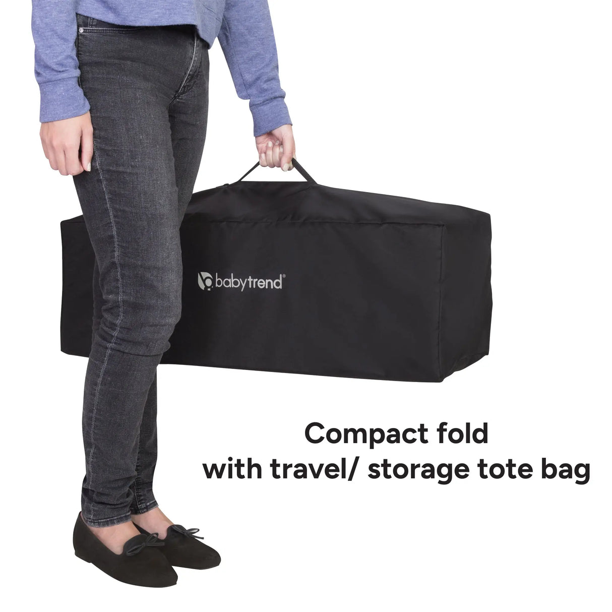A mother holding the Baby Trend Willow Nursery Center Playard while compacted fold with travel storage tote bag