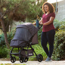 Load image into gallery viewer, Mom is outdoor with her child in the Baby Trend Passport Carriage Stroller