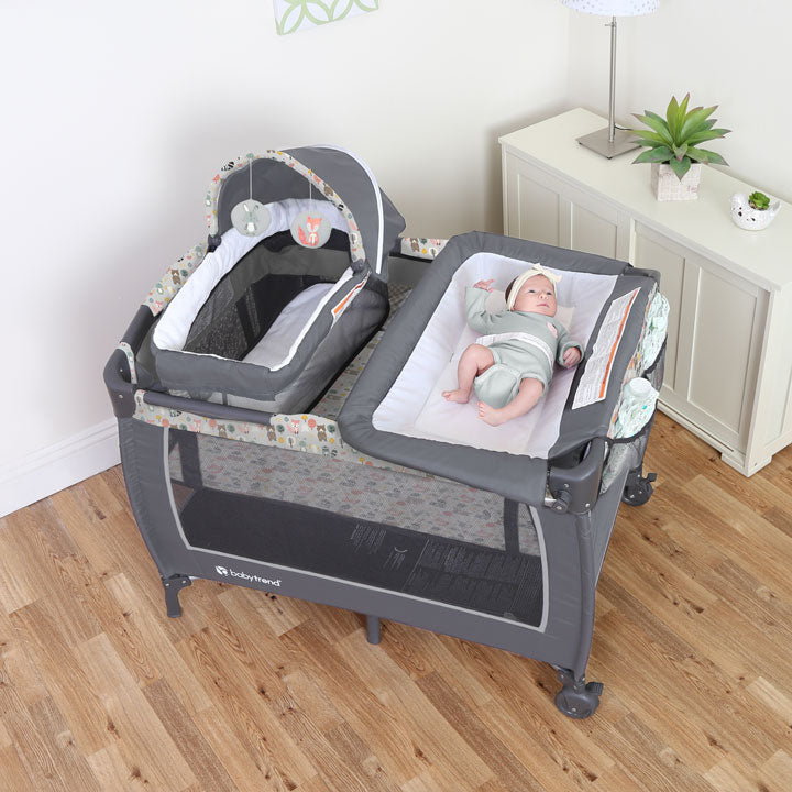 A baby on the changing table, Baby Trend Nursery Center Playard with new born napper and changing table