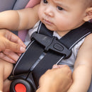 Load image into gallery viewer, A parent is making sure the harness system is not twisted by using the No-Twist indicator on the Baby Trend Secure-Lift Infant Car Seat