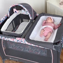 Load image into gallery viewer, Baby infant laying on the changing table of the Baby Trend Lil' Snooze Deluxe II Nursery Center Playard