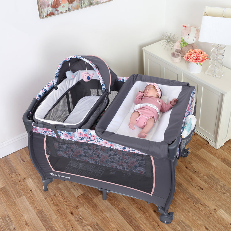 Baby infant laying on the changing table of the Baby Trend Lil' Snooze Deluxe II Nursery Center Playard