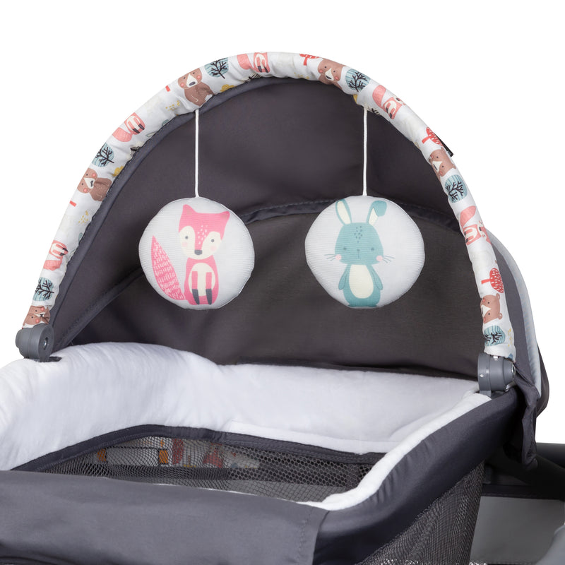 Two hanging toys on the napper included in the Baby Trend Lil’ Snooze Deluxe II Nursery Center Playard