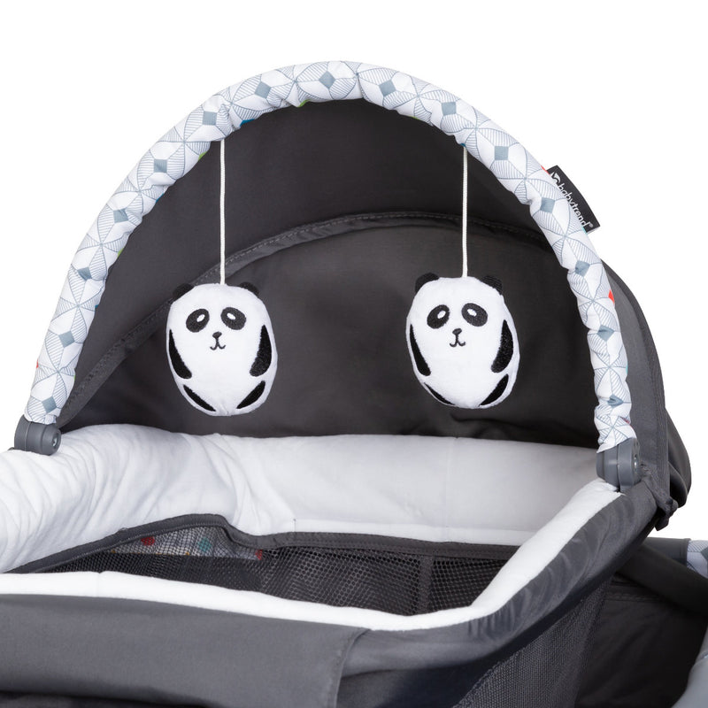 Two hanging toys on the napper of the Lil Snooze Deluxe Nursery Center Playard
