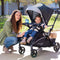Baby Trend Sit N Stand 5-in-1 Shopper Stroller of mom and child riding in the front seat
