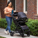 Load image into gallery viewer, Baby Trend Passport Cargo Stroller Travel System with EZ-Lift 35 PLUS Infant Car Seat mom strolling with car seat in stroller