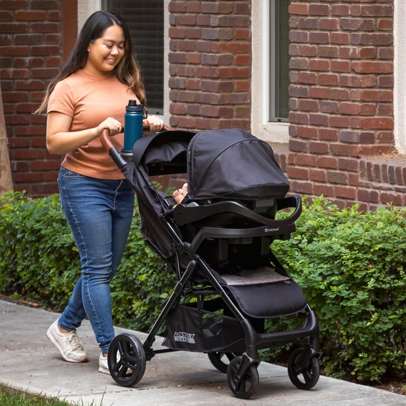 Baby Trend Passport Cargo Stroller Travel System with EZ-Lift 35 PLUS Infant Car Seat mom strolling with car seat in stroller
