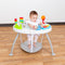 A girl baby playing and sitting on the Baby Trend 3-in-1 Bounce N Play Activity Center