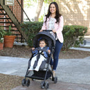 Load image into gallery viewer, Mom is strolling with her baby in the Baby Trend Jetaway Compact Stroller lightweight stroller 