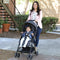 Mom is strolling with her baby in the Baby Trend Jetaway Compact Stroller lightweight stroller 