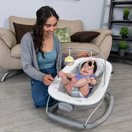 Woman playing with baby in Baby Trend bouncer