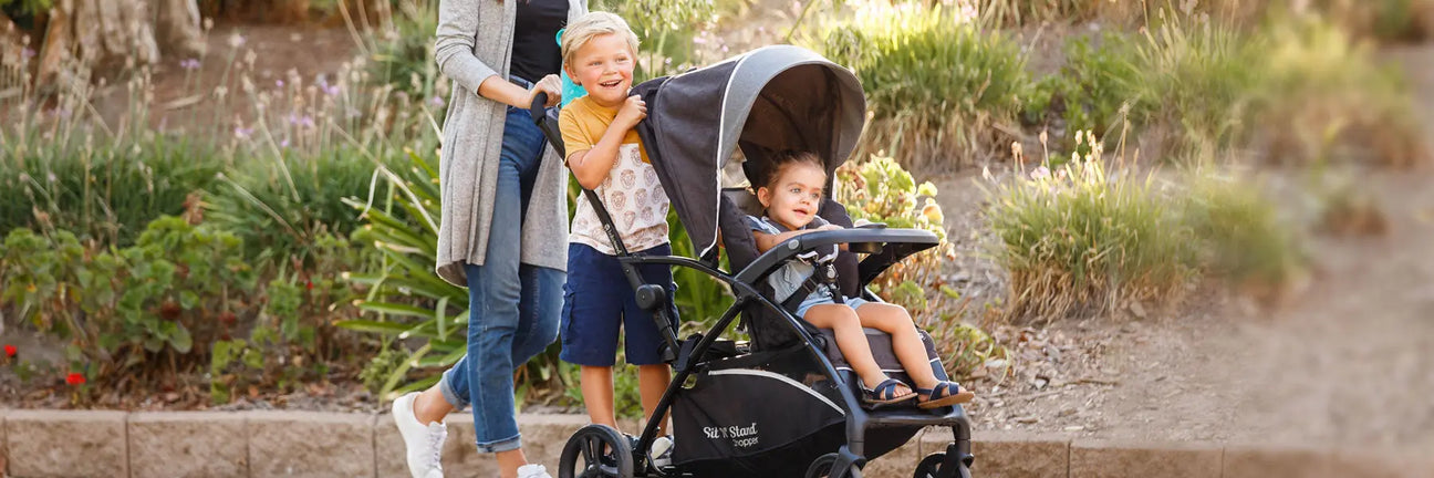 Baby Trend Sit N Stand 5-in-1 Shopper Travel System sit a child in the front and child in the back with stand on platform
