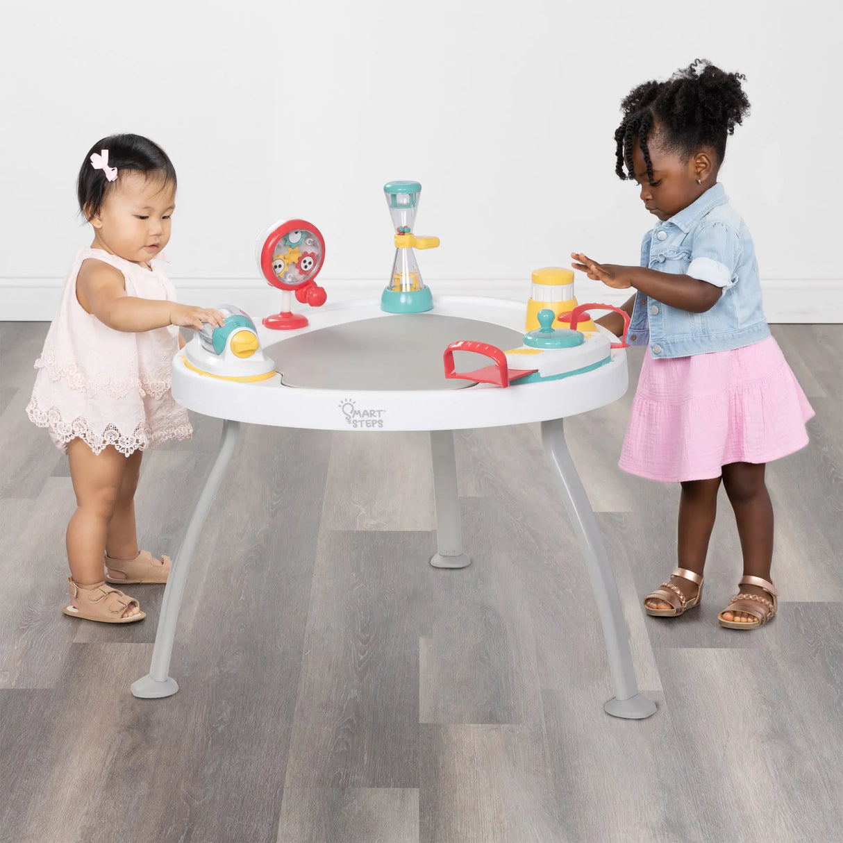 Two children playing with the Smart Steps Hop N' Discover 3-in-1 Activity Center
