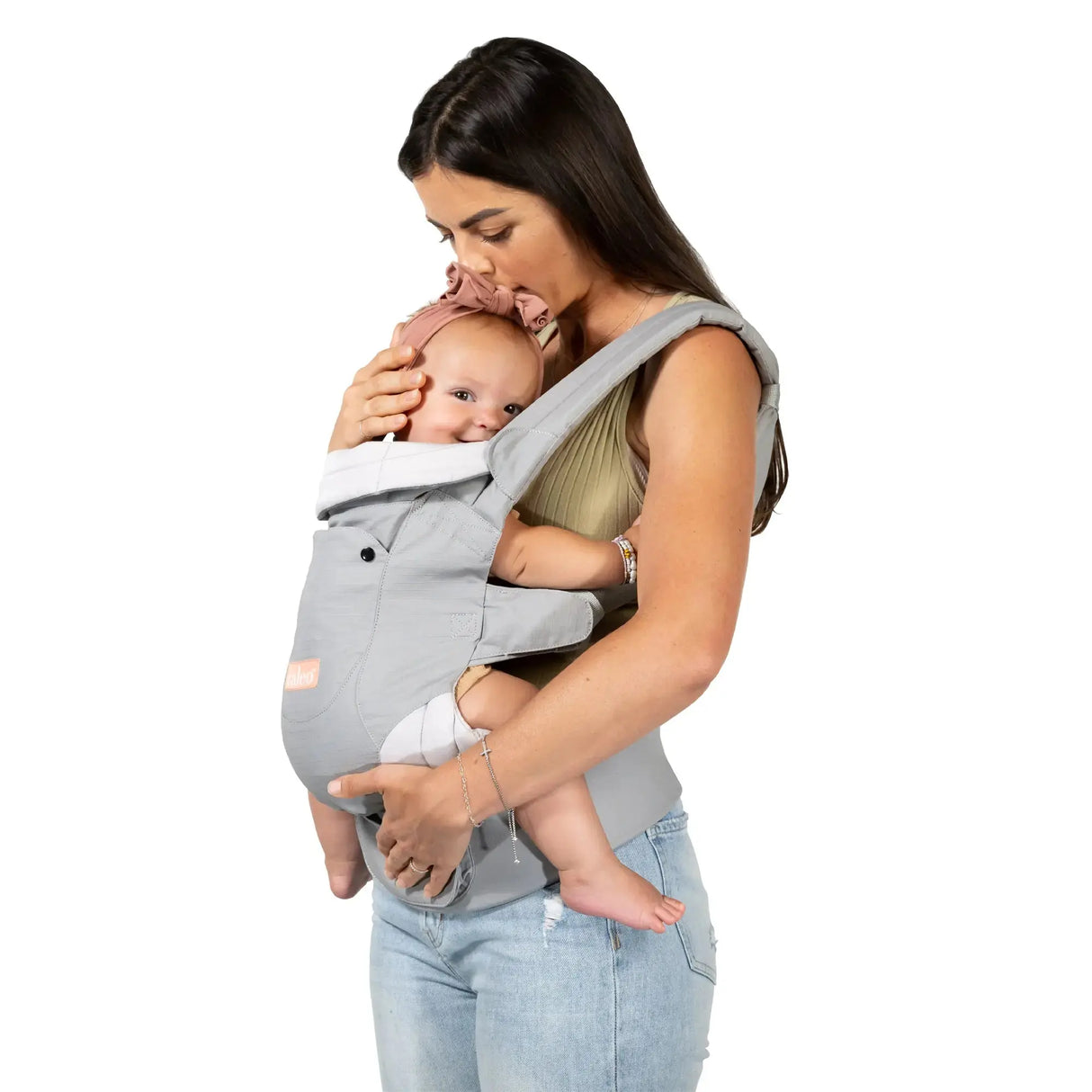 Mom is carrying her child in the 
Caleo 3-in-1 Newborn Carrier