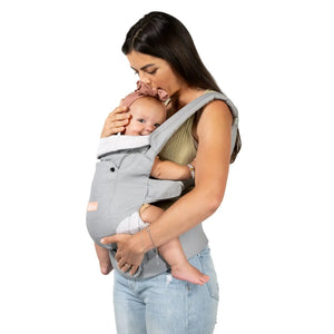 Mom is carrying her child in the 
Caleo 3-in-1 Newborn Carrier