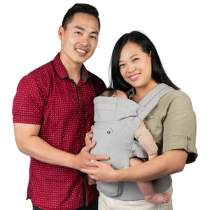 Parents carrying their child with the Baby Trend Caleo Charm Deluxe 3-in-1 Newborn Carrier