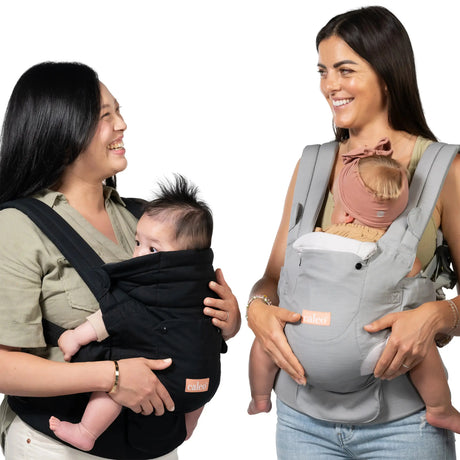 Parents carrying their child with the Baby Trend Caleo Charm Deluxe 3-in-1 Newborn Carrier