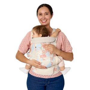 A mom is carrying her child in the Baby Trend Newborn Carrier