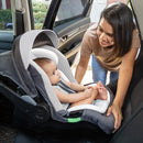 Load image into gallery viewer, A mom is looking after her child sitting in the Baby Trend Secure-Lift LTE Infant Car Seat