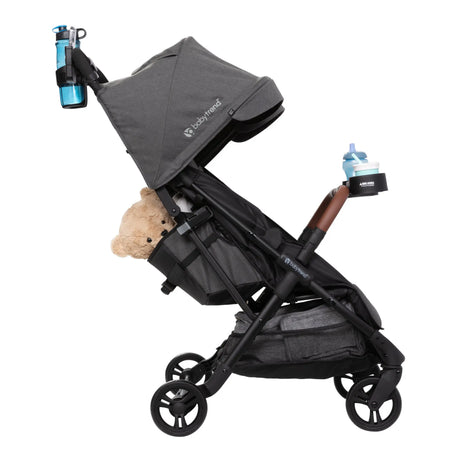 Baby Trend York Compact Side-By-Side Double Stroller with cup holders and a teddy bear 