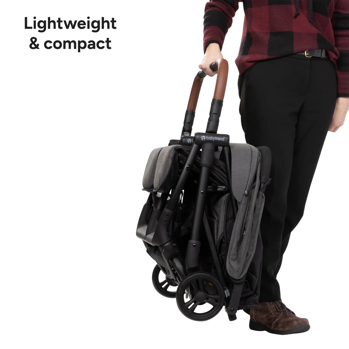 Person holding a compact and lightweight Baby Trend York Compact Side-By-Side Double Stroller