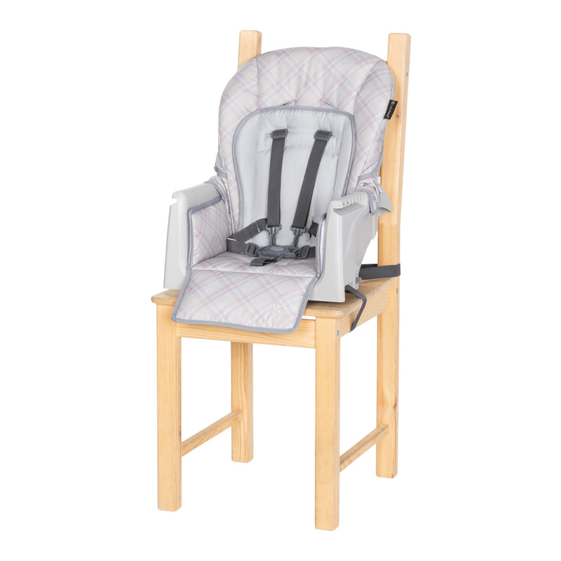 Baby Trend Everlast 7-in-1 High Chair in toddler booster mode on a chair