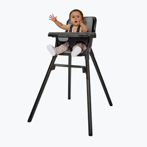 A child sitting in the Baby Trend Sweet Seat 4-in-1 High Chair