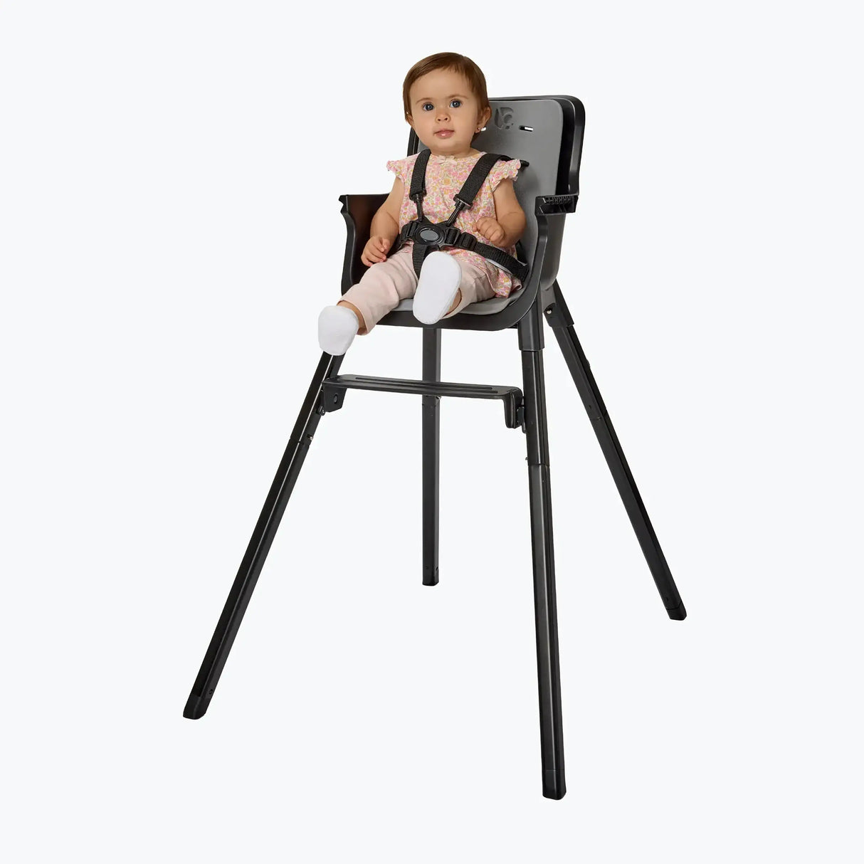 A child is sitting in the Baby Trend Sweet Seat 4-in-1 High Chair