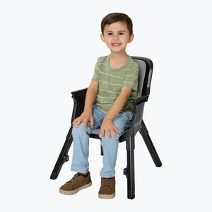 A toddler sitting in the Baby Trend Sweet Seat 4-in-1 High Chair