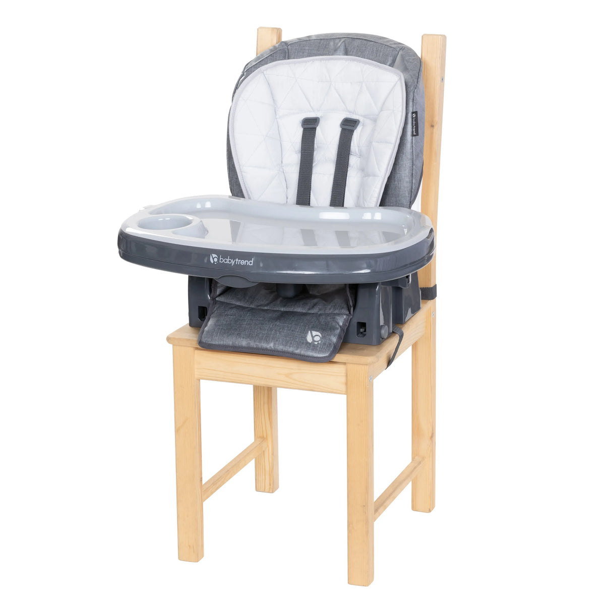 The 7-In-1 Feeding Center High Chair seat is removed and placed on a dining chair