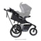 Side view of the Baby Trend Expedition DLX Jogger Stroller with infant car seat attached, sold separately