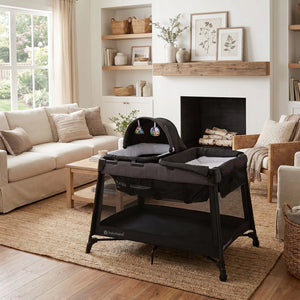 The Baby Trend Willow Nursery Center Playard is set in the living room of a home