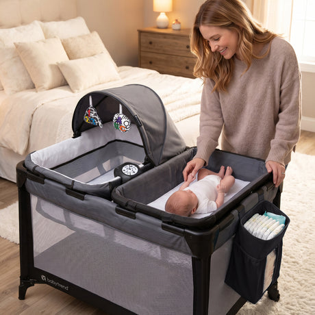 A mom is watching her child laying on the changing table of the Baby Trend Willow Nursery Center Playard