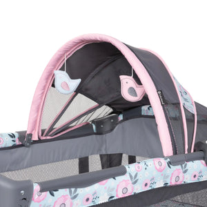 The canopy of the Baby Trend Deluxe II Nursery Center Playard has two hanging toys