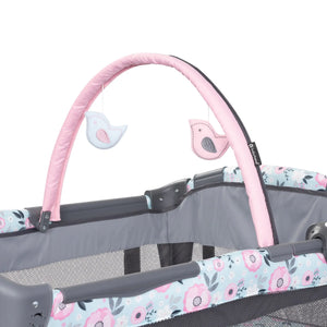 The toy bar on the Baby Trend Deluxe II Nursery Center Playard with two hanging toys