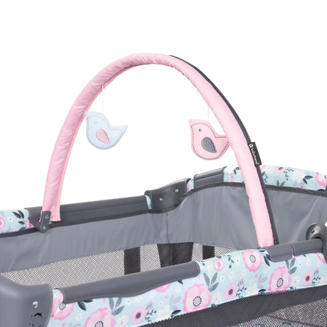 The toy bar on the Baby Trend Deluxe II Nursery Center Playard with two hanging toys