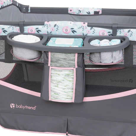 The parents diapers organizer on the side of the Baby Trend Deluxe II Nursery Center Playard