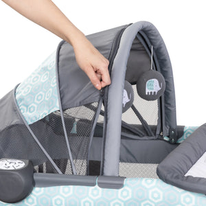 The canopy of the Baby Trend EZ Rest Deluxe Nursery Center can be unzipped into a toy bar