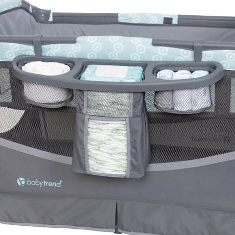 The parent diaper organizer on the side of the Baby Trend EZ Rest Deluxe Nursery Center