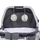 Load image into gallery viewer, The portable cradle has two hanging toys on the canopy of the Baby Trend Nursery Den Playard with Rocking Cradle