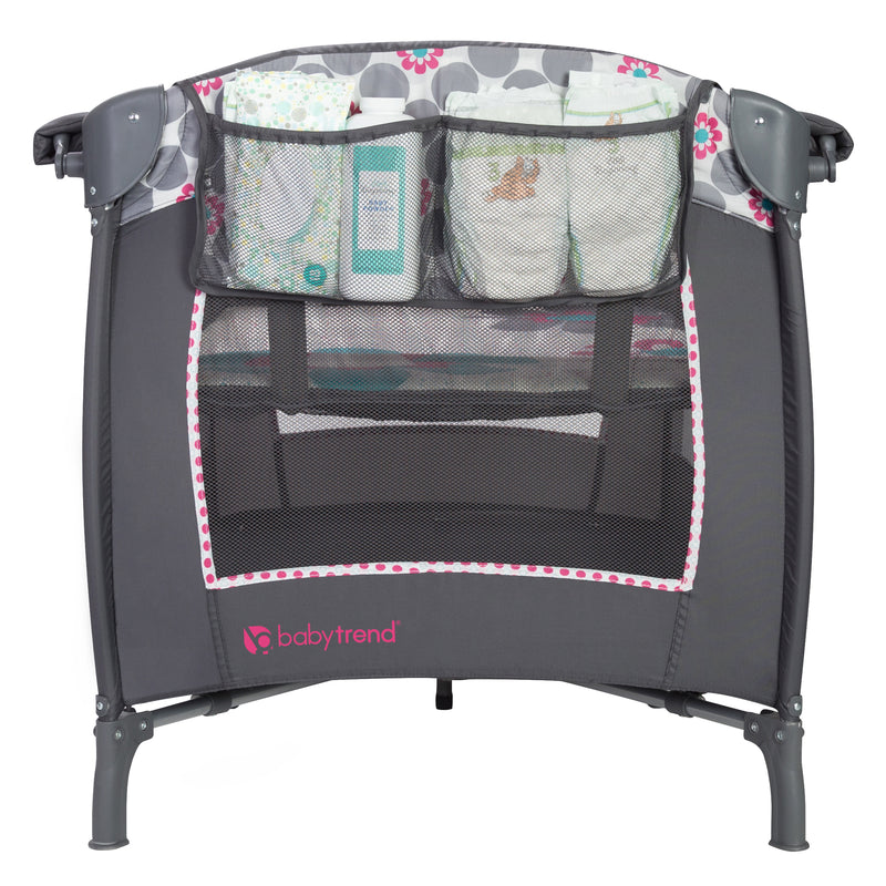 Side mesh diaper storage on the Baby Trend Lil' Snooze Deluxe II Nursery Center Playard