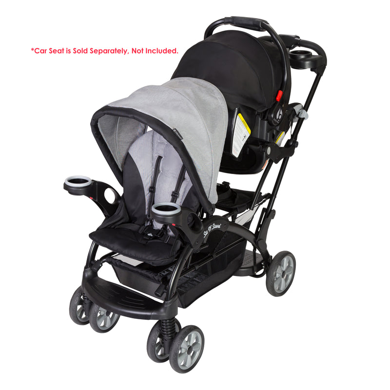 Baby Trend Sit N' Stand Ultra Stroller with infant car seat in the rear seat, sold separately