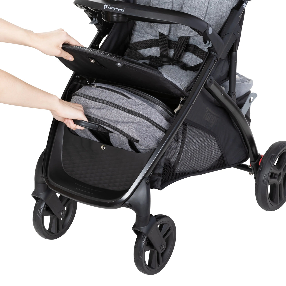 A person is accessing the front storage basket of the Baby Trend Tango Stroller
