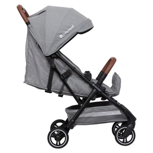 Side view of the Baby Trend Zenda Compact All-Terrain Stroller child's seat reclined and foot rest adjusted
