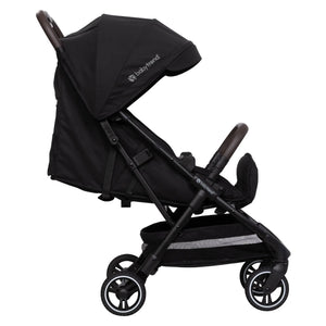 Side view of the Baby Trend Zenda Compact All-Terrain Stroller child's seat reclined and foot rest adjusted