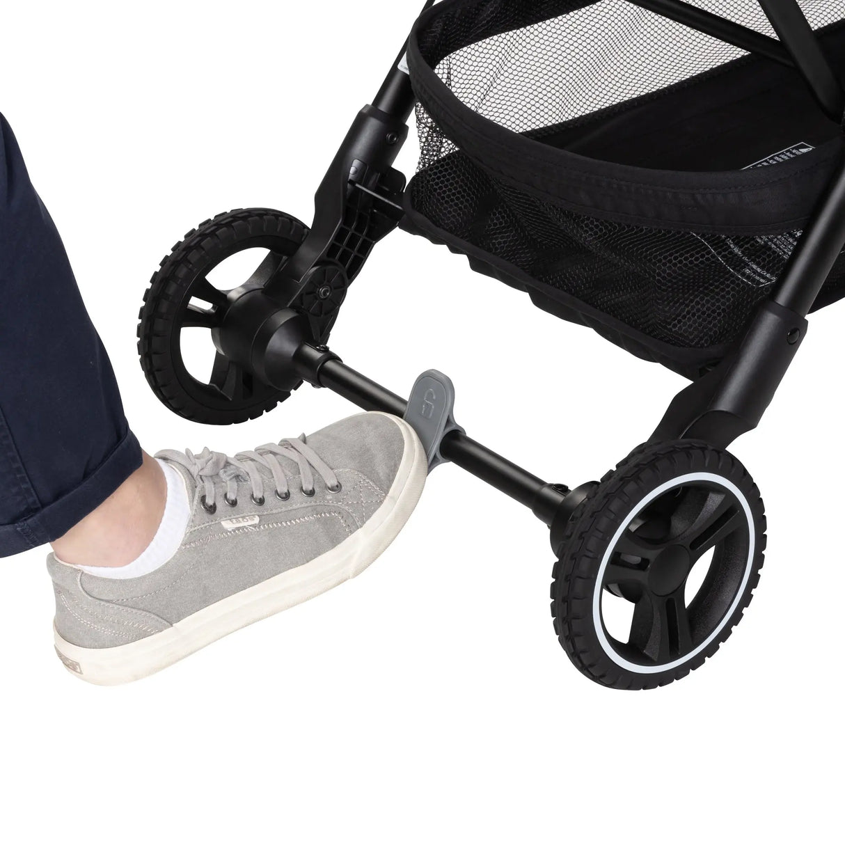 A person is pushing on the brake of the Baby Trend Zenda Compact All-Terrain Stroller 