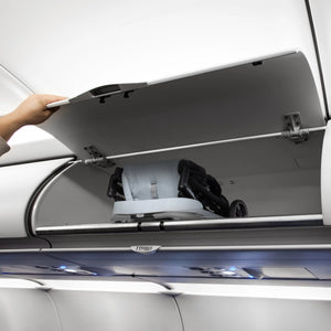The Baby Trend Zenda Compact All-Terrain Stroller is folded and placed into the bin of an airplane