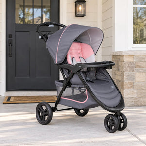 The Baby Trend EZ Ride Stroller is parked in front of a door home