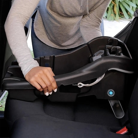 A mom is stalling the base of the Baby Trend EZ-Lift PRO Infant Car Seat into a car 